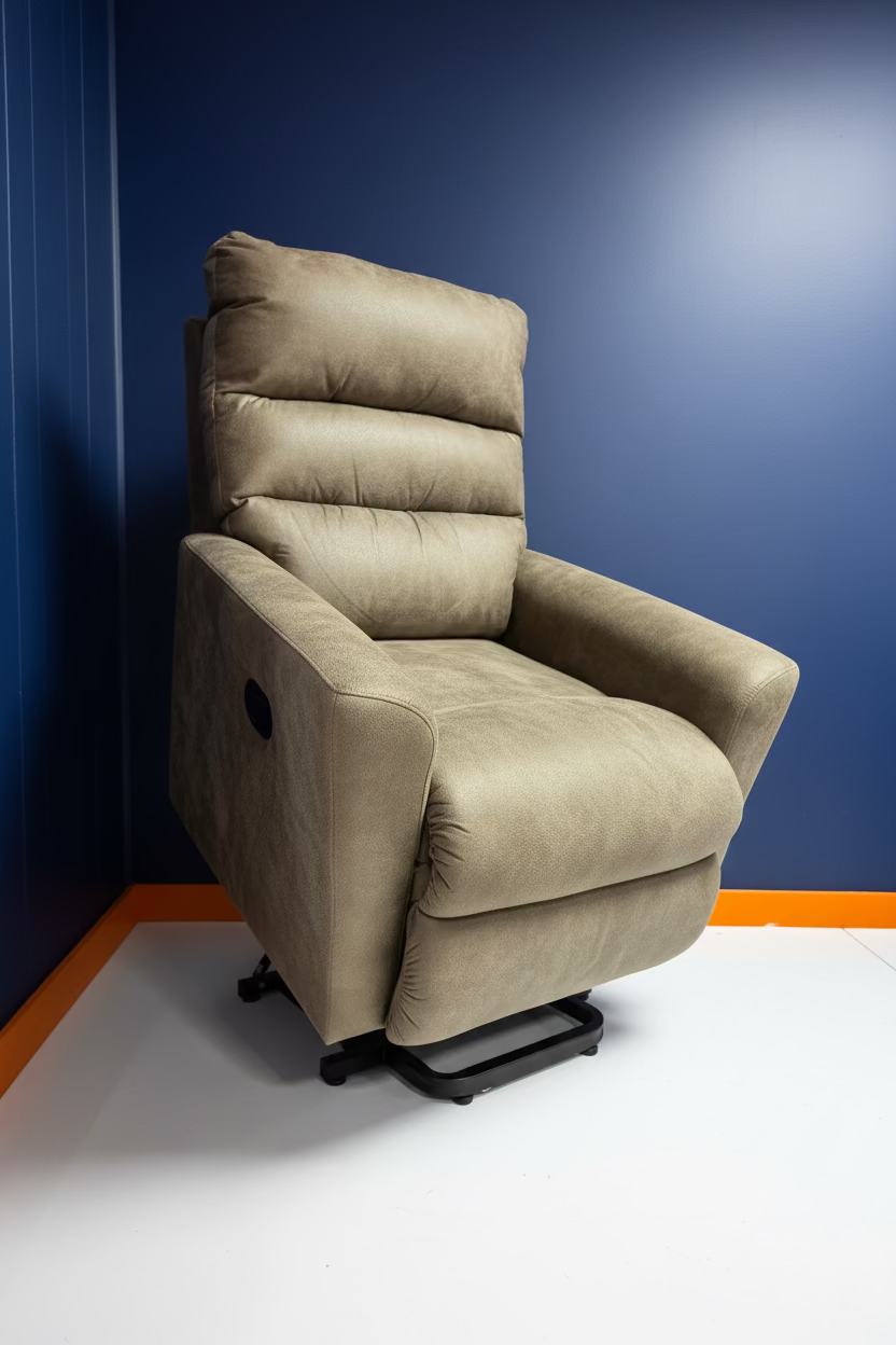 A beige upholstered recliner chair with a black footrest and a small wired remote control, photographed indoors against a blue wall with partial white and orange branding visible.