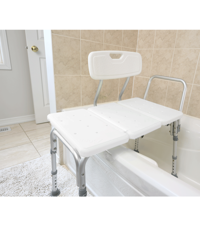 Transfer bath bench with backrest positioned over bathtub in bathroom