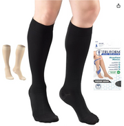 Black compression socks on a person's legs with a Truform packaging in the background.