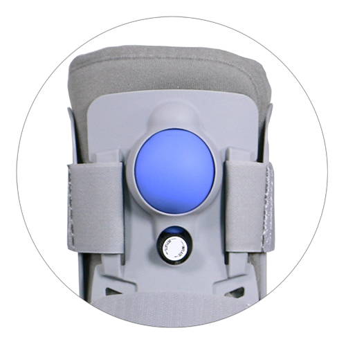 Closeup of grey air CAM walking boot showing blue pneumatic air bladder and black inflation valve — detail view of adjustable air pump compression system for customized ankle support