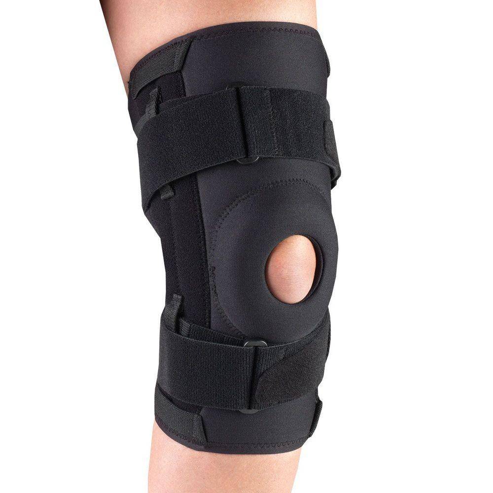 Black neoprene knee brace with open patella cutout, bilateral hinged side stays, and three adjustable velcro straps worn on leg — side view showing structured knee stabilization, wraparound neoprene sleeve, and D-ring buckle closure for ligament support