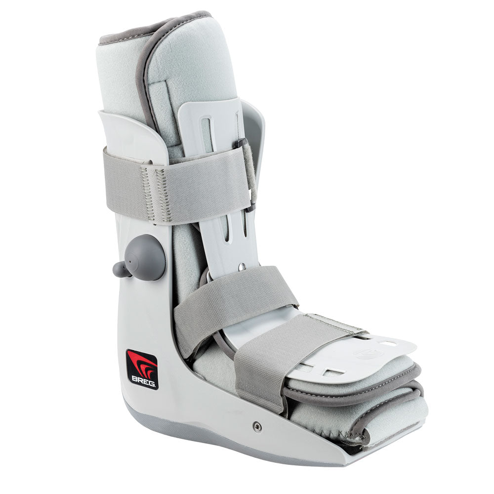 Breg Genesis Mid-Calf Walking Boot in white and grey – compact low-cut ankle walker with plush foam collar, side air pump, two wide velcro straps, and cushioned footbed, angled side view on white background