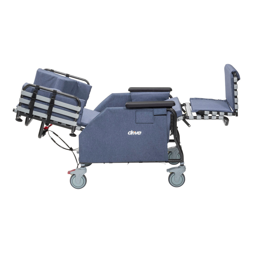 Drive tilt-and-recline chair side view in fully flat reclined position with leg rest fully extended, casters, and blue upholstery — available at Must in Metro Vancouver