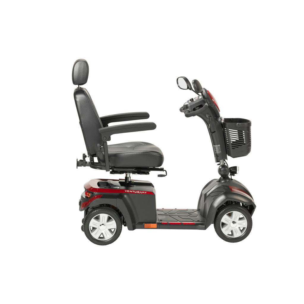 Left side profile of Drive Ventura DLX 4-wheel mobility scooter in red and black showing high-back captain seat, flat armrests, tiller with mirror, front basket, and spoke wheels
