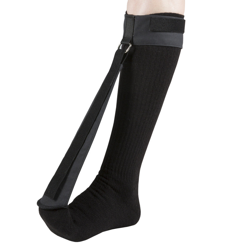 OTC 2097 plantar fasciitis night splint sock worn on lower leg and foot, side view showing black knit compression sock, padded calf strap with D-ring, and tension strap holding foot in dorsiflexion
