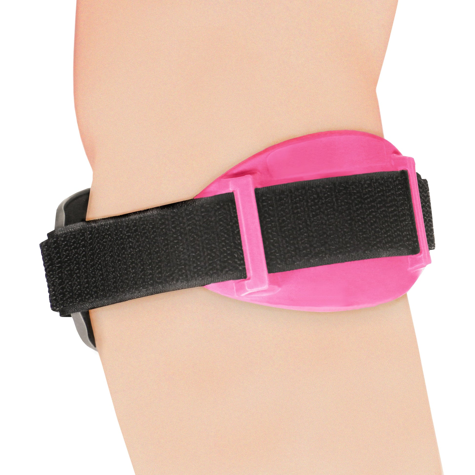 Side view of OTC 2421 tennis elbow brace in pink on forearm showing pink oval hard shell pressure pad, black elastic strap through centre channel guide, and metal snap buckle
