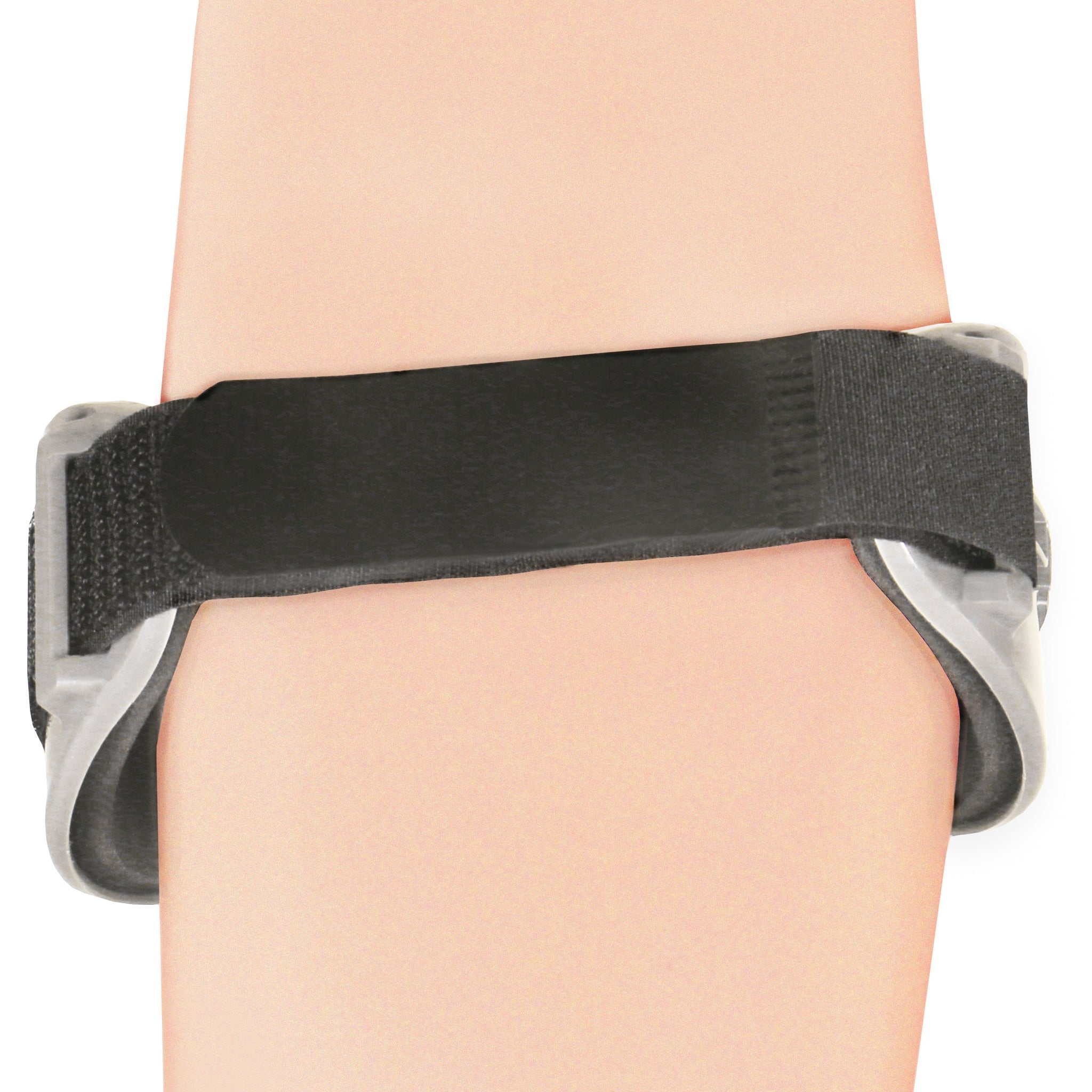 Rear view of OTC 2421 tennis elbow brace on forearm showing black elastic strap wrapping around arm, grey oval pressure pad edges on both sides, and velcro closure tab
