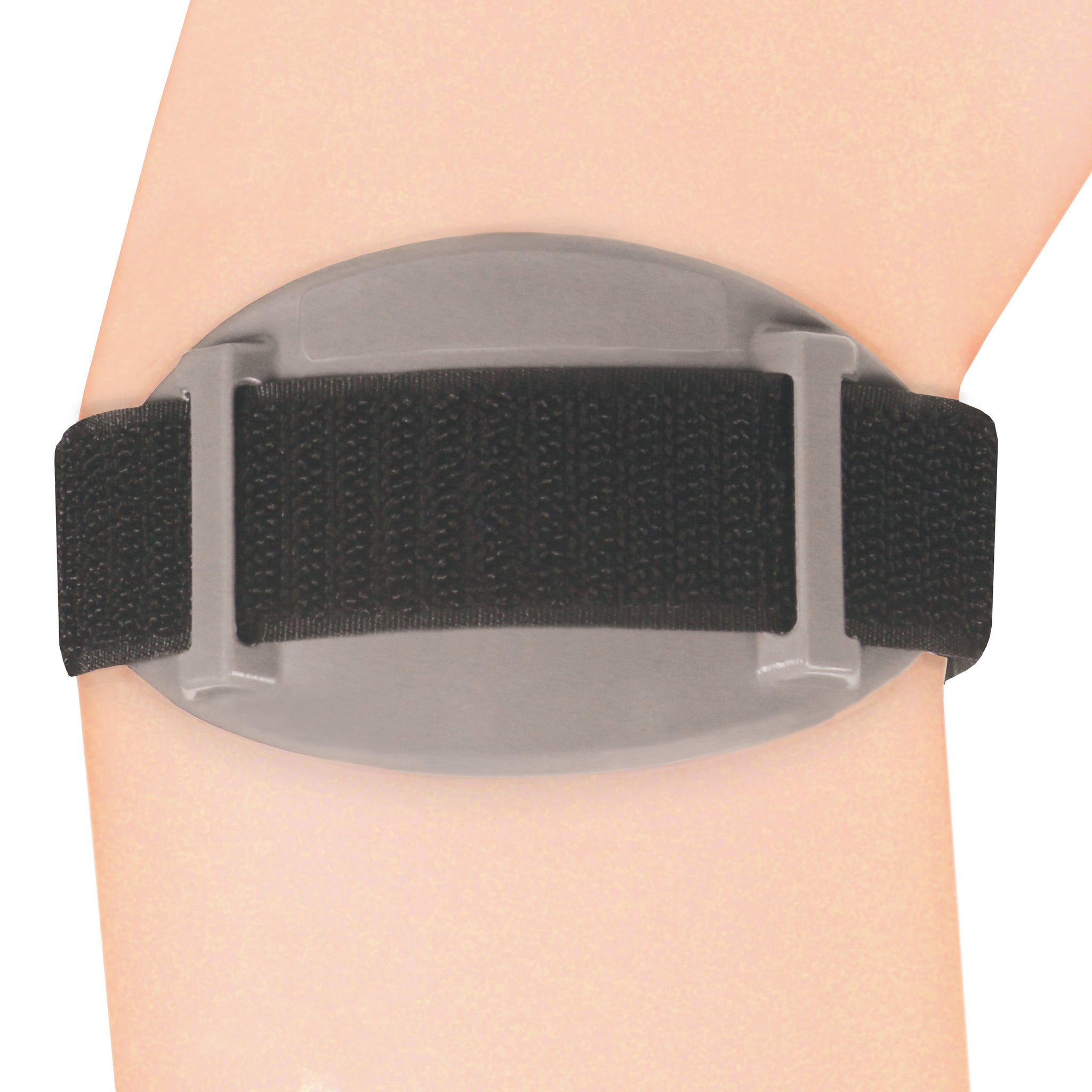 Underside view of OTC 2421 tennis elbow brace on forearm showing grey oval hard shell back plate with dual strap channel guides and black elastic strap threaded through
