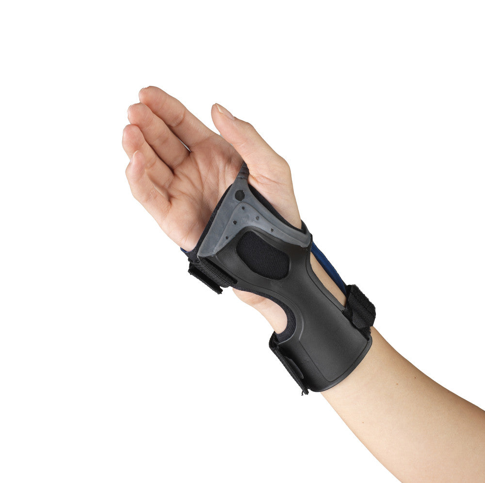 OTC low profile wrist brace worn on right hand, palm-up view showing rigid dorsal shell with ventilation holes, blue stay, velcro straps, and open palm design
