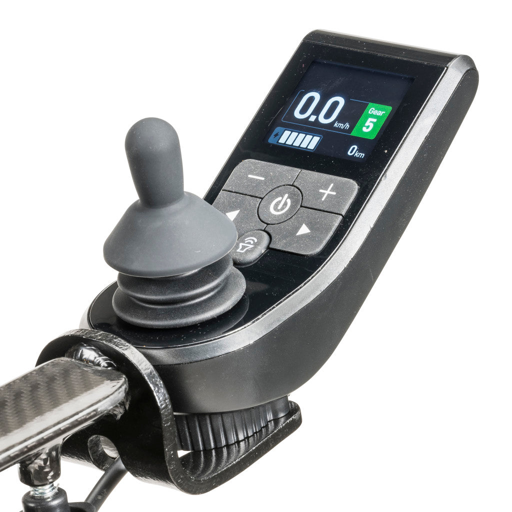Close-up of a power wheelchair joystick controller with digital LCD display showing speed, gear 5, and battery level indicator