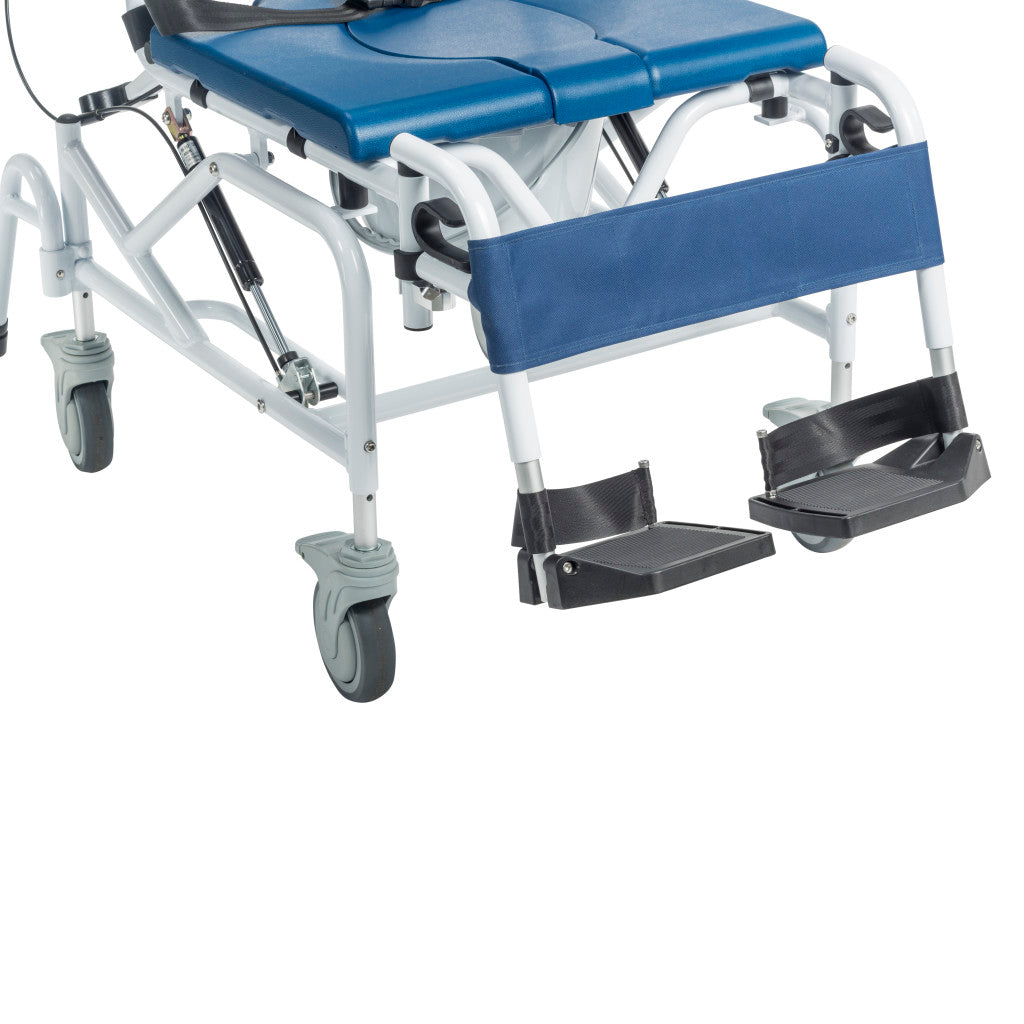 Close-up of rehab shower chair lower frame showing adjustable black foot supports, blue leg rest pad, swivel locking casters, gas spring strut, and tilt cable mechanism