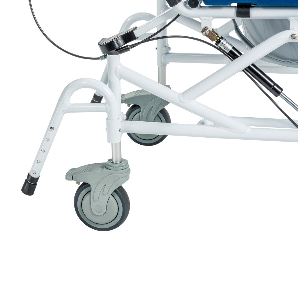 Close-up of rehab shower chair rear base showing swivel locking caster, adjustable anti-tip leg, tilt cable mechanism, gas spring strut, and white cross-brace steel frame