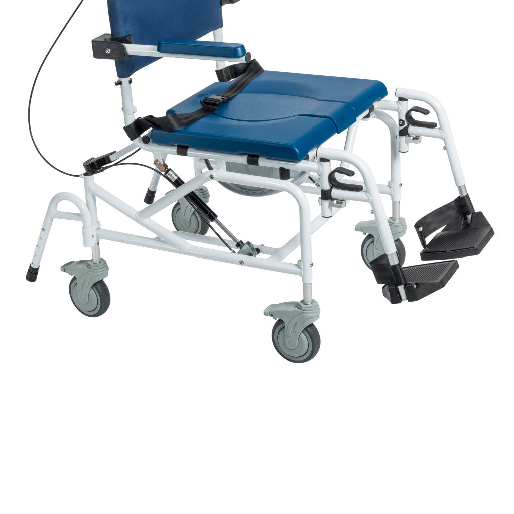 Rehab shower commode chair 3/4 rear view showing blue padded seat with lap belt, leg rest, foot support, four swivel locking casters, gas spring strut, and tilt cable mechanism
